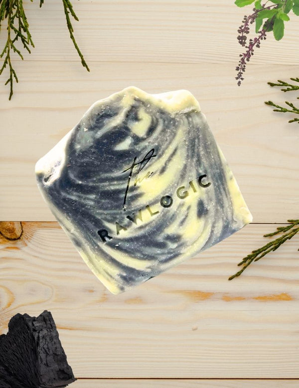 Hexagonal soap bar with 'Raw Logic' branding on a wooden surface with greenery.