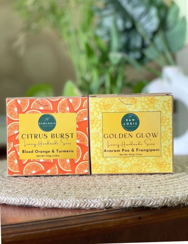 Two soap boxes labeled 'Citrus Burst' and 'Golden Glow' on a white background with a yellow flower.