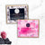 Two soap packages, one labeled 'Charcoal Magic' and the other 'Garden Rose', on a marble surface with decorative elements.