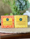 Two soap boxes labeled 'Citrus Burst' and 'Golden Glow' on a white background with a yellow flower.